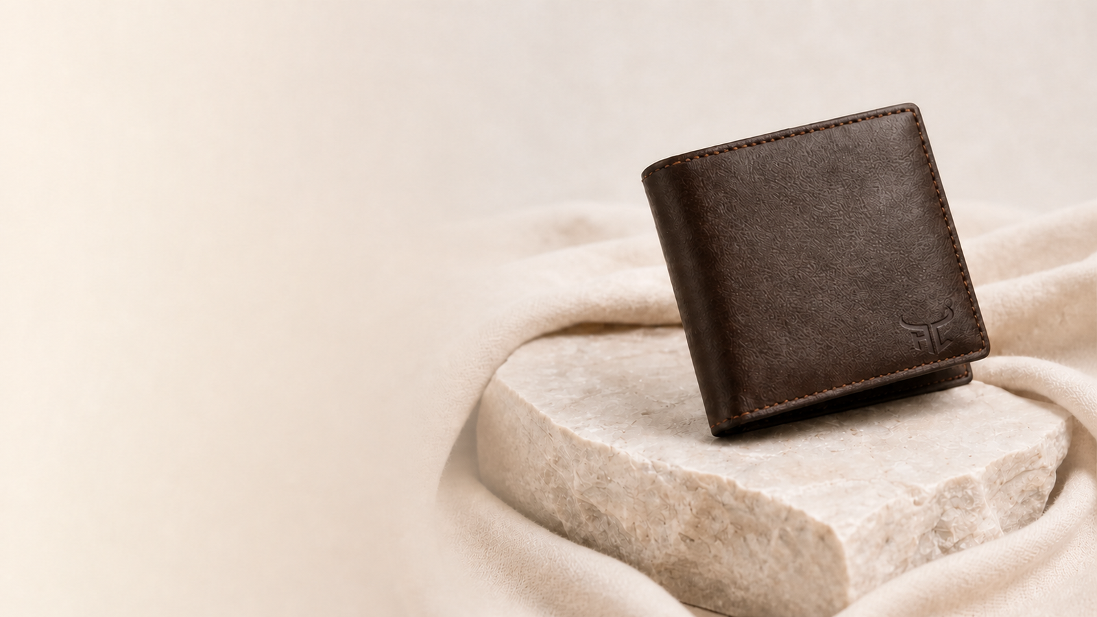 Highlark brown leather wallet on pale stone
